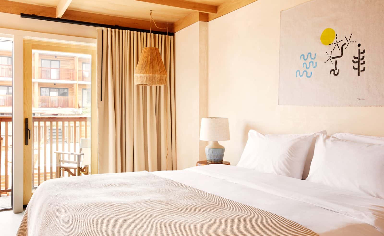 Marram Montauk bedroom with soft linen bedding and blue wall art