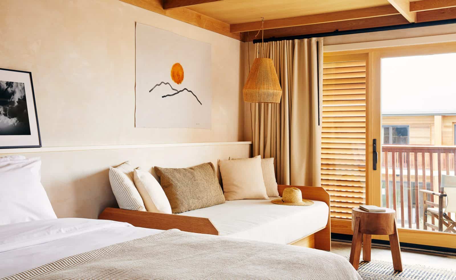 Marram Montauk guest room with warm tones and coastal wall art