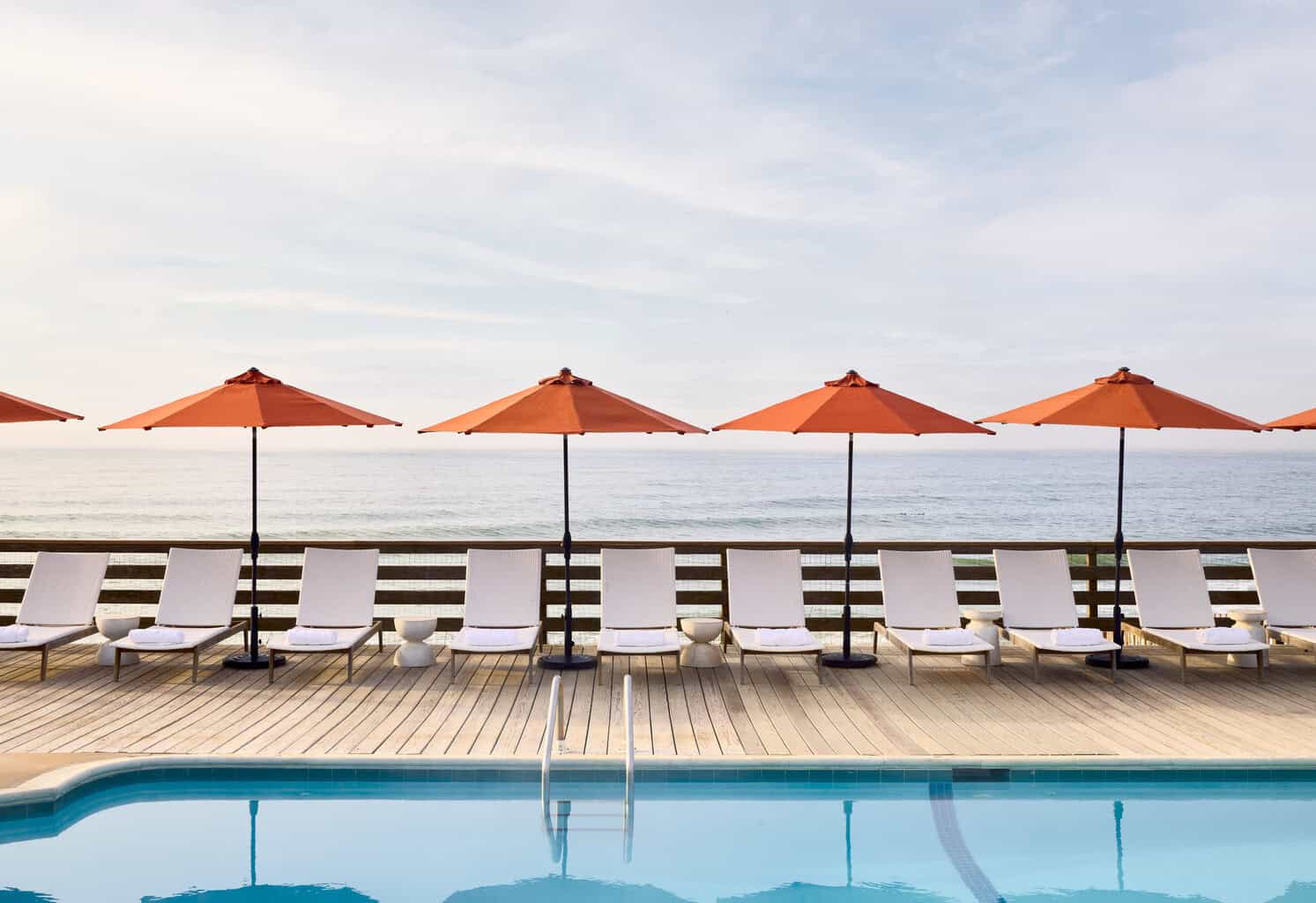 Marram Montauk pool deck with orange umbrellas and ocean views