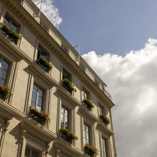 The 19th-century facade of J.K. Place Paris on Rue de Lille