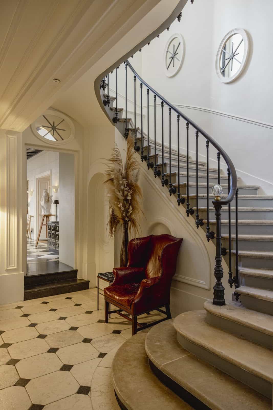 The curved staircase in the entrance hall at J.K. Place Paris