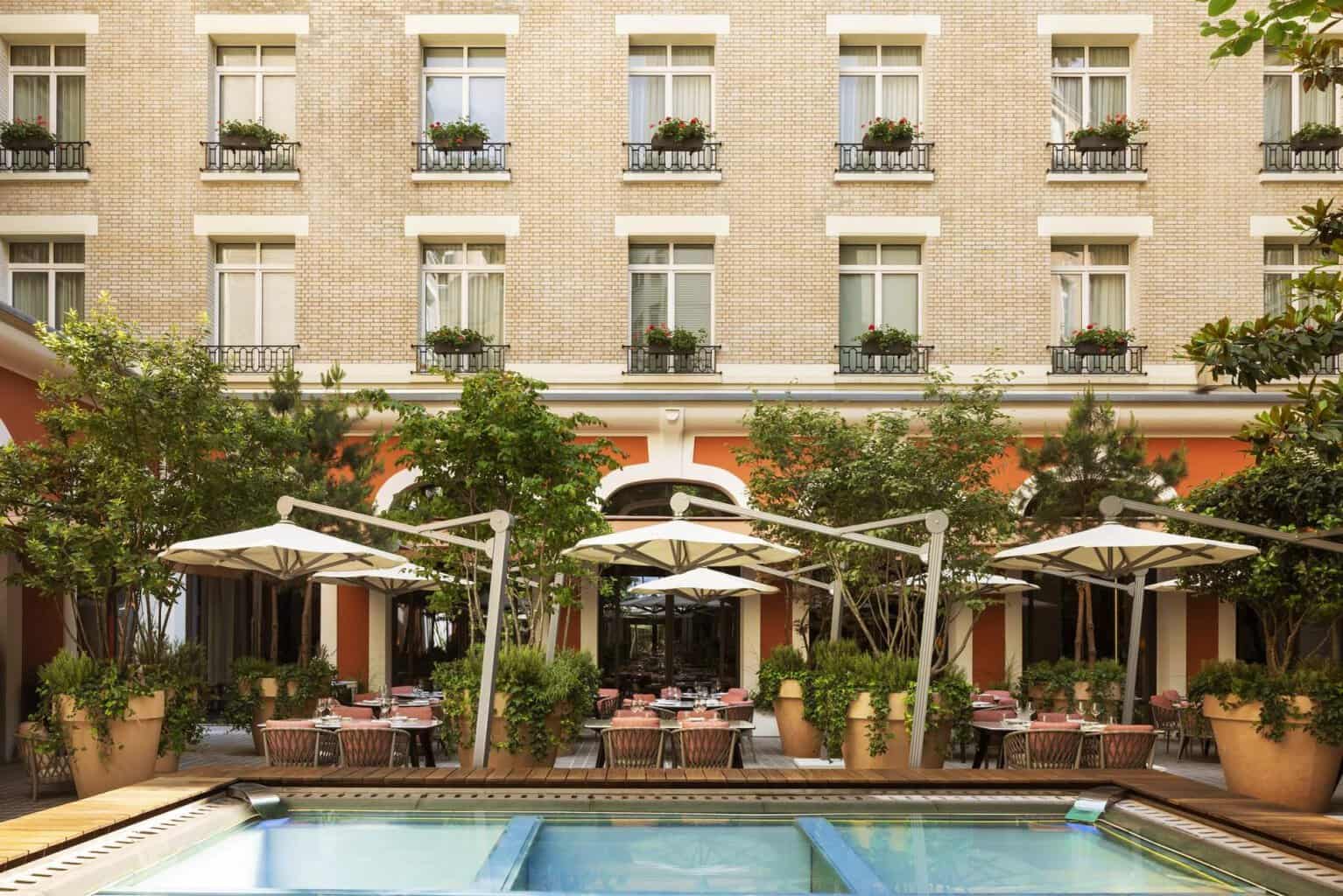 The garden courtyard and pool at Le Royal Monceau Raffles Paris