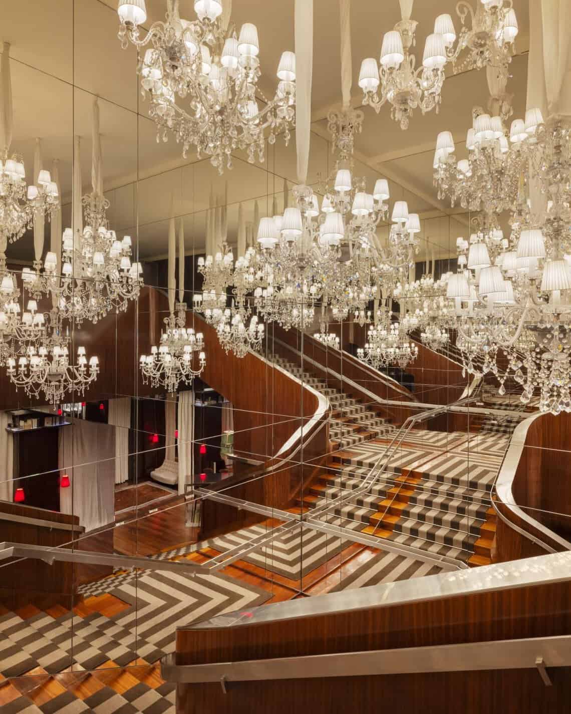 The mirrored staircase lit by Baccarat crystal chandeliers at Le Royal Monceau