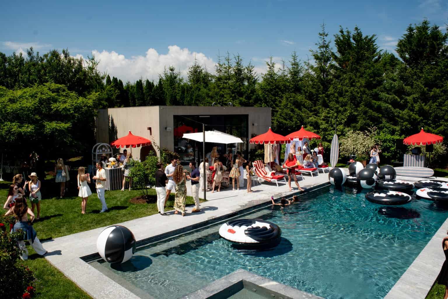 Guests gathered poolside at Stacey Bendet's Water Mill summer celebration