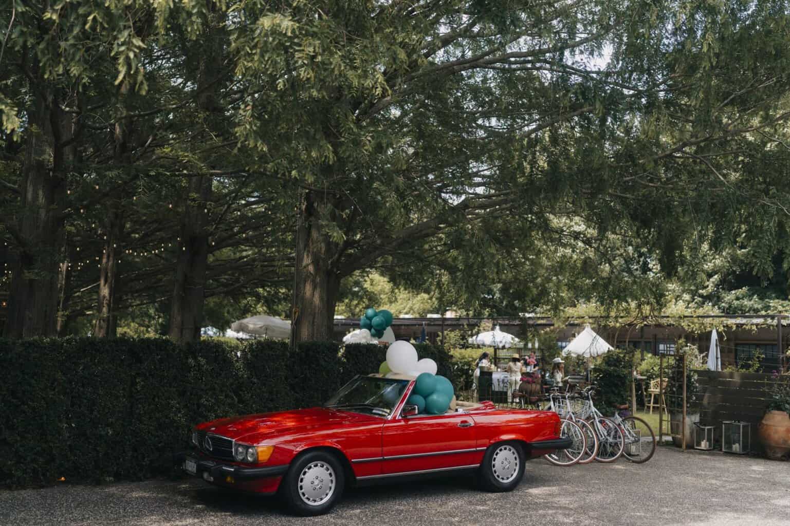 Vintage Mercedes convertible with balloons at the Rexford Drive launch in the Hamptons