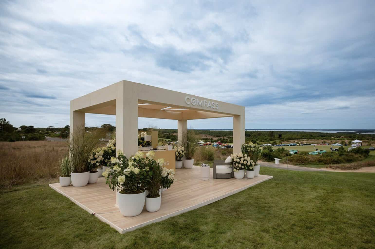 A custom white pergola by Decco set on the lawn