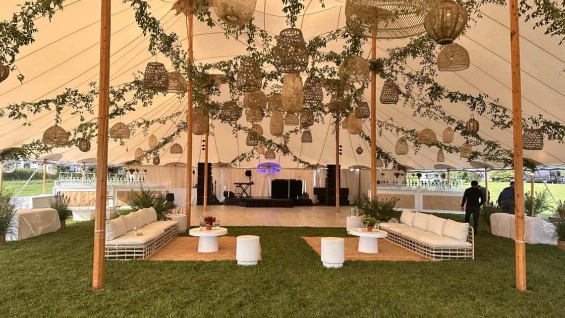 A Decco by Party Up Productions lounge and tent setup at a Hamptons event
