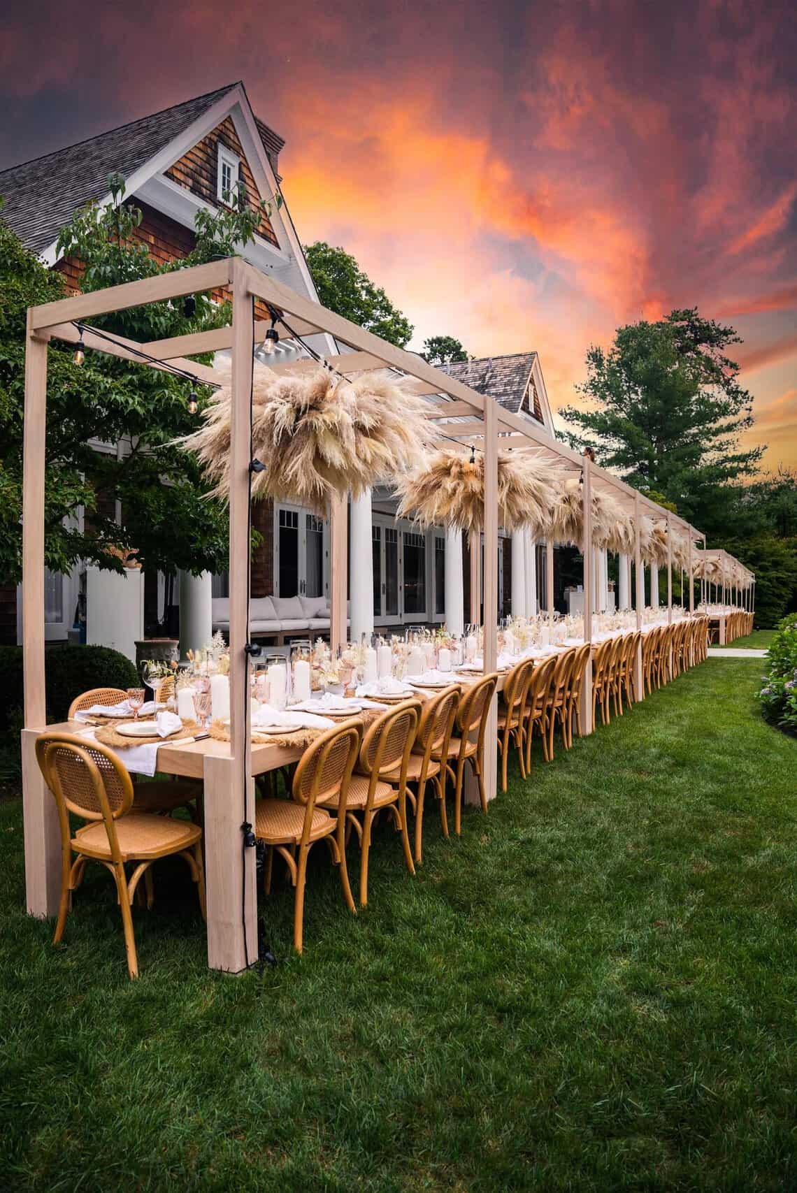 A Decco pergola dinner setting at sunset in the Hamptons