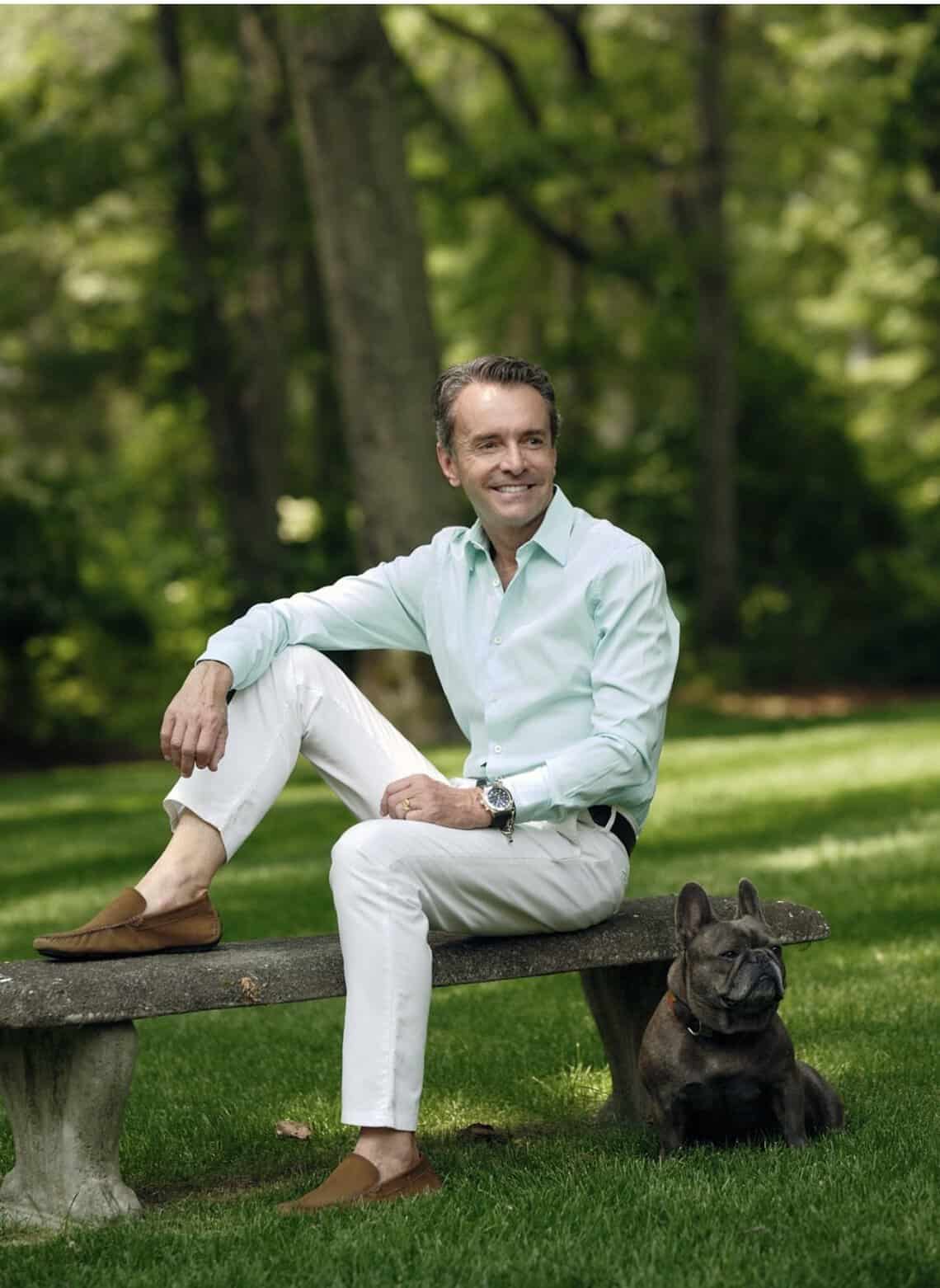 Frederico Azevedo, founder of Unlimited Earth Care, in a Hamptons garden with his French Bulldog Louis