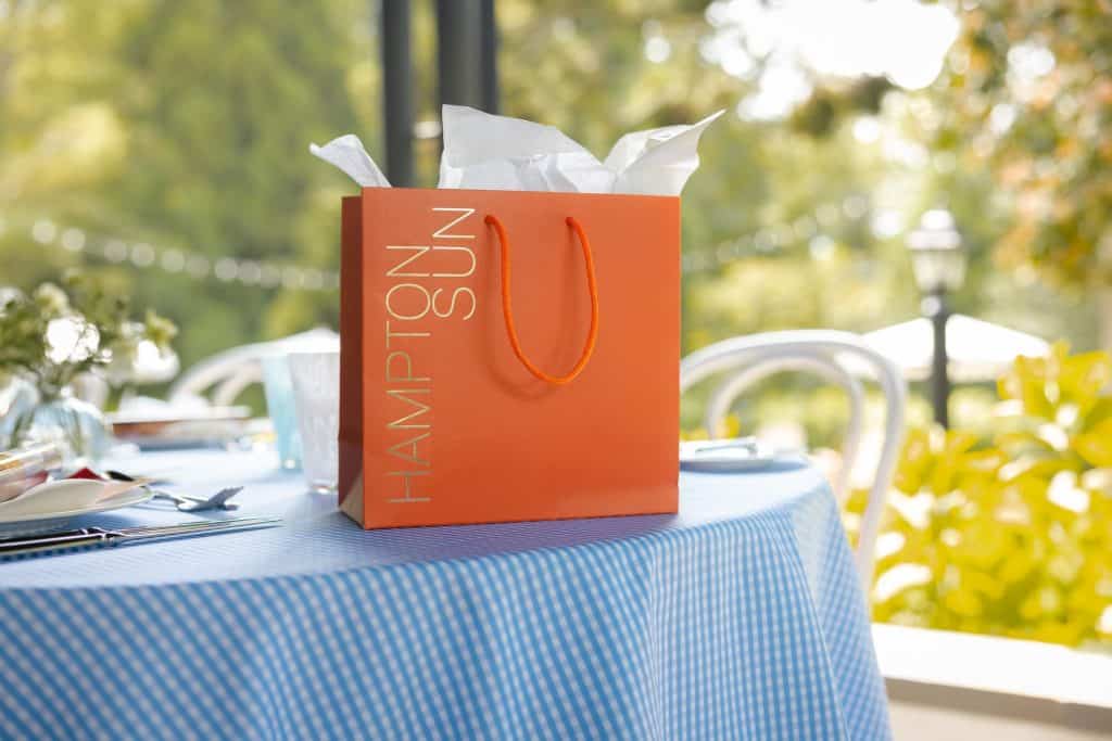 A Hampton Sun gift bag on the table at The Hedges Inn luncheon